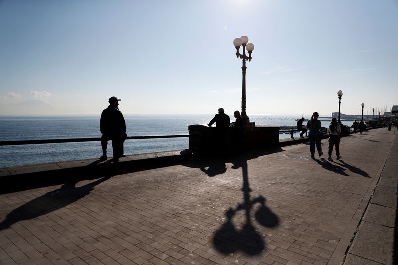 &copy; Reuters. People walk on the waterfront, as the spread of the coronavirus disease (COVID-19) continues, in Naples, Italy November 27, 2020. REUTERS/Yara Nardi/File Photo