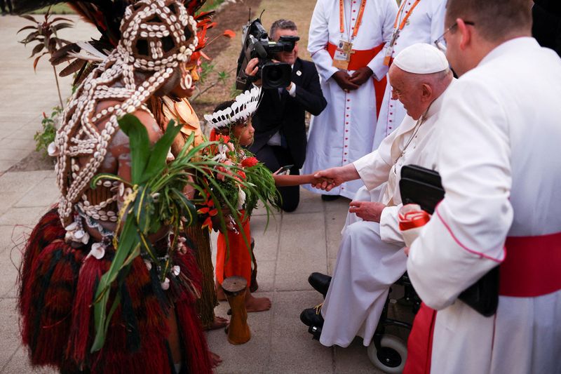 &copy; Reuters. Pope Francis is welcomed by Indigenous people on the day he meets with bishops of Papua New Guinea and Solomon Islands, priests, deacons, consecrated persons, seminarians and catechists at the Shrine of Mary Help of Christians in Port Moresby, Papua New G