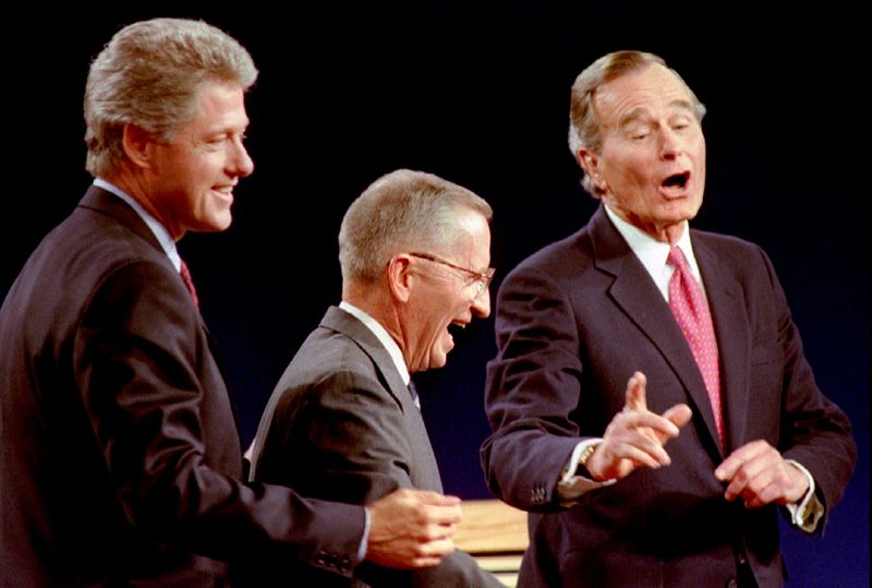 © Reuters. FILE PHOTO: Democratic Presidential nominee Governor Bill Clinton (L) Independent candidate Ross Perot (C) and President George Bush laugh at the conclusion of their Presidential debate in East Lansing, Michigan, U.S., October 19th, 1992. REUTERS/Mark Cardwell/File Photo