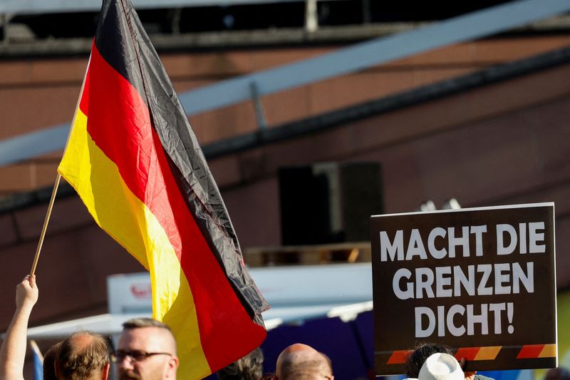 © Reuters. FILE PHOTO: A person holds a poster reading: 