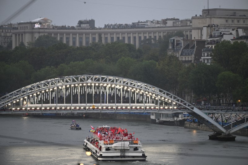 © Reuters. FILE PHOTO: A boat carrying members of delegations sails along the Seine during the opening ceremony of the Paris 2024 Olympic Games, France   Hu Huhu/Pool via REUTERS/File Photo