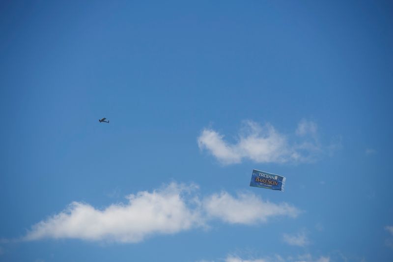 © Reuters. FILE PHOTO: A plane flies an advertisement for Trojan Bareskin condoms over the concert grounds on the second day of the Firefly Music Festival in Dover, Delaware U.S., June 15, 2018. REUTERS/Mark Makela/File Photo