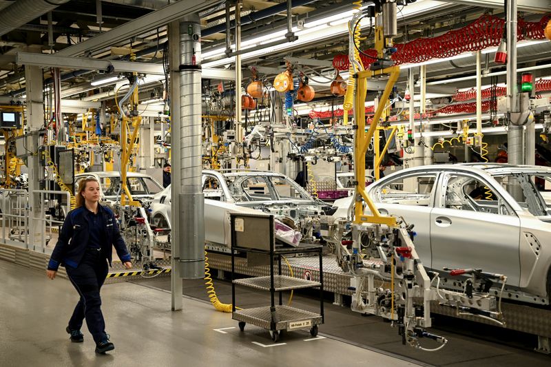 © Reuters. FILE PHOTO: A woman walks inside the BMW Group plant in Munich, Germany, December 5, 2023. REUTERS/Angelika Warmuth/File Photo