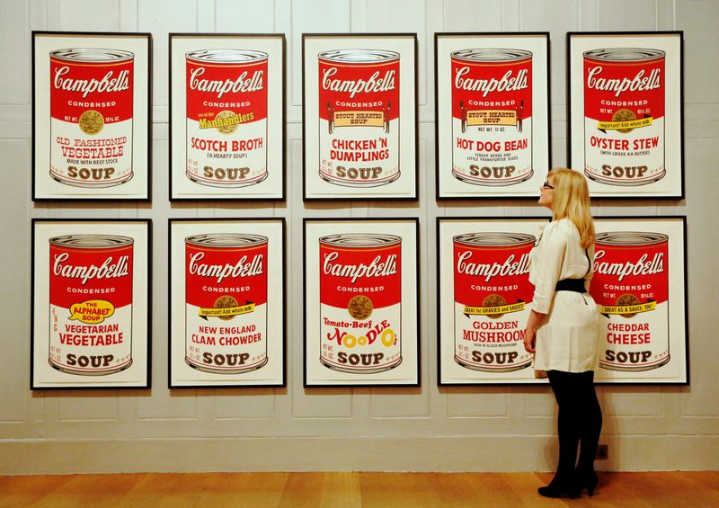 © Reuters. FILE PHOTO: Gallery employee Maddy Adeane poses with Andy Warhol's 