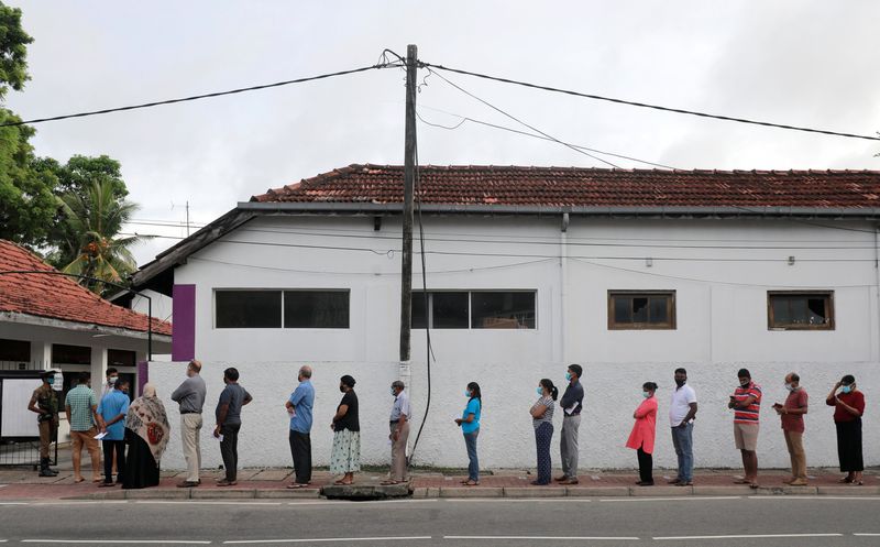 © Reuters. People wearing protective masks wait in a line outside a polling station as they prepare to cast their vote during the country's parliamentary election in Colombo, Sri Lanka, August 5, 2020. REUTERS/Dinuka Liyanawatte/ File Photo