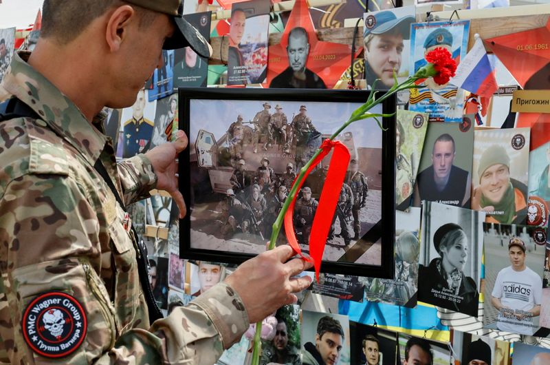 © Reuters. FILE PHOTO: A man stands in front of a makeshift memorial, which was erected following head of Russia's Wagner mercenary group Yevgeny Prigozhin and group commander Dmitry Utkin's death in 2023, during a commemoration ceremony held to pay tribute to Wagner fighters, who were recently killed in Mali by northern Tuareg rebels, in central Moscow, Russia August 4, 2024. REUTERS/Yulia Morozova/File Photo