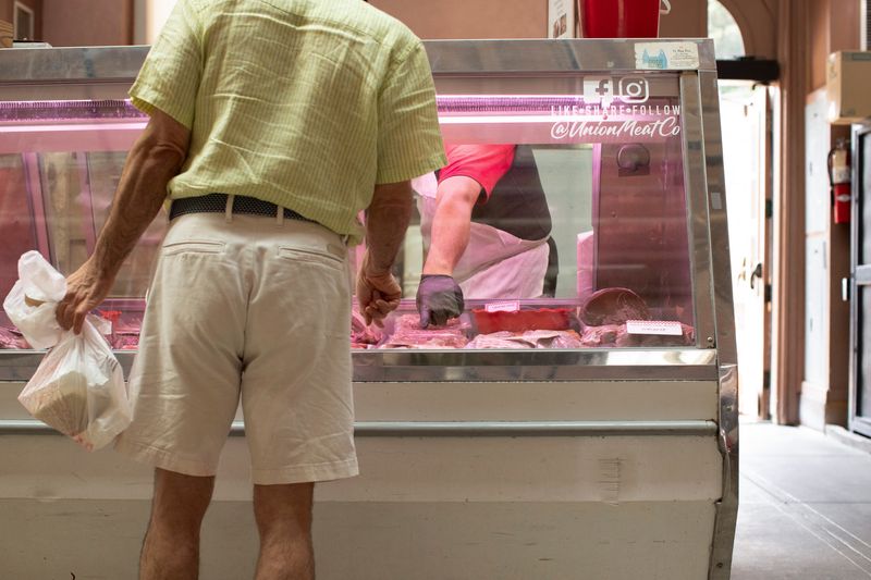 &copy; Reuters. FILE PHOTO: A man shops for meat from a butcher at Eastern Market in Washington, U.S., August 14, 2024. REUTERS/Kaylee Greenlee Beal/File Photo