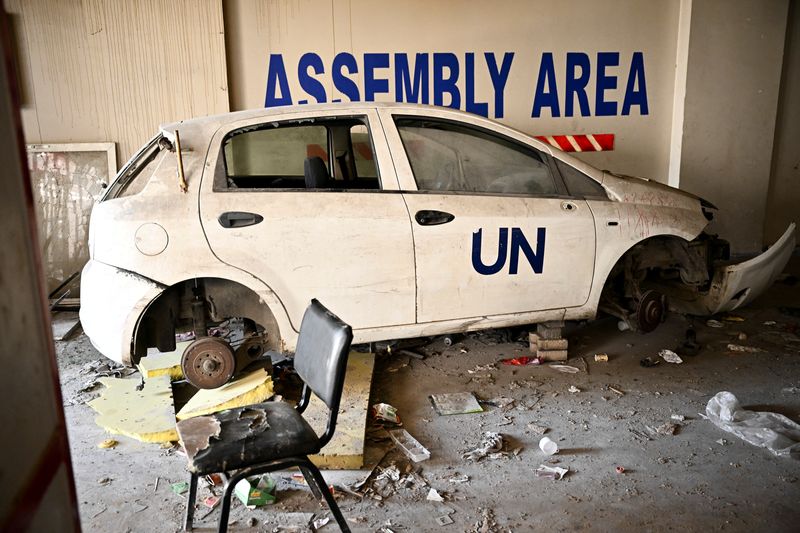 © Reuters. FILE PHOTO: A view shows a damaged car with a 