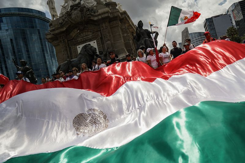 © Reuters. Demonstrators display a large Mexico flag as they protest at the Angel of Independence after a highly contested judicial reform proposal was passed in the Senate in Mexico City, Mexico September 11, 2024. REUTERS/Toya Sarno Jordan