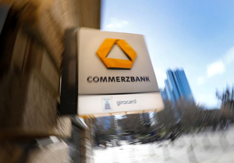 © Reuters. FILE PHOTO: A sign for an ATM of Commerzbank is seen next to the headquarters of Deutsche Bank (R) in Frankfurt, Germany, March 19, 2019.  REUTERS/Kai Pfaffenbach/File Photo