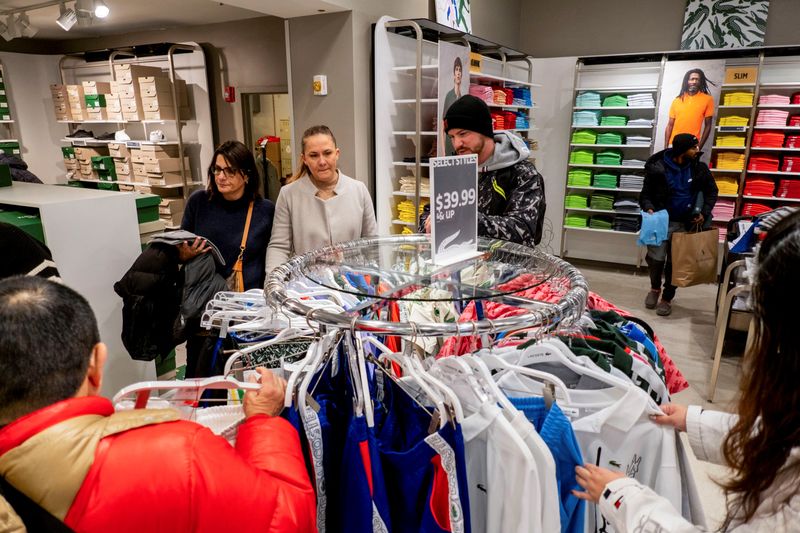 &copy; Reuters. FILE PHOTO: Black Friday shoppers pick out clothing in a Lacoste store as retailers compete to attract shoppers and try to maintain margins on Black Friday, one of the busiest shopping days of the year, at Woodbury Common Premium Outlets in Central Valley