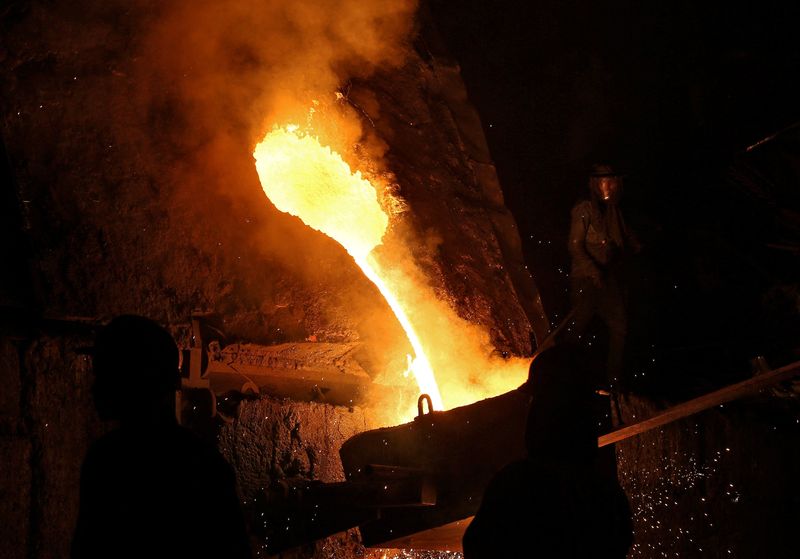 &copy; Reuters. FILE PHOTO: A worker observes an electric furnace inside a steel factory on the outskirts of Jammu February 12, 2018. Picture taken February 12, 2018. REUTERS/Mukesh Gupta/File Photo