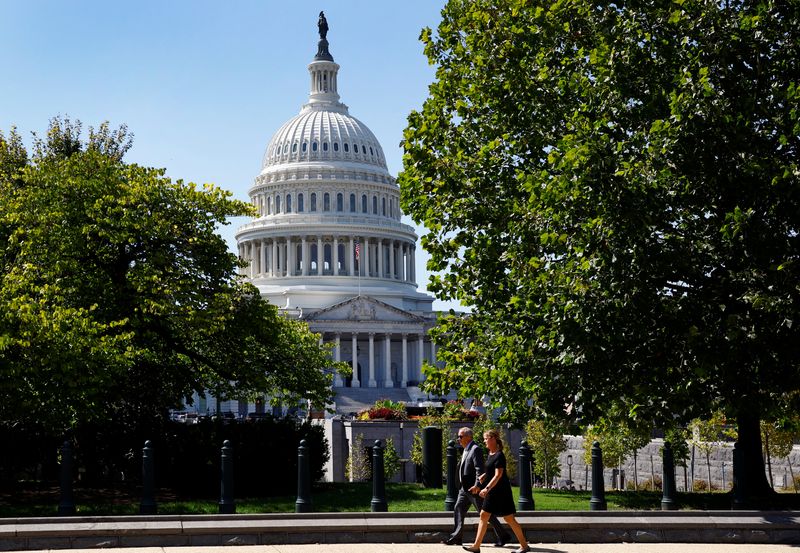 © Reuters. A woman and a man walk in front of the U.S. Capitol in Washington, DC, U.S., September 10, 2024. REUTERS/Piroschka van de Wouw/File 
Photo