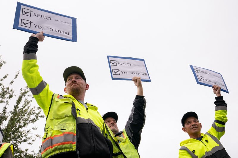 © Reuters. Boeing factory workers hold signs in support of a strike as they vote on their first full contract in 16 years, at an International Association of Machinists and Aerospace Workers District 751 union hall, in Renton, Washington, U.S. September 12, 2024.  REUTERS/David Ryder