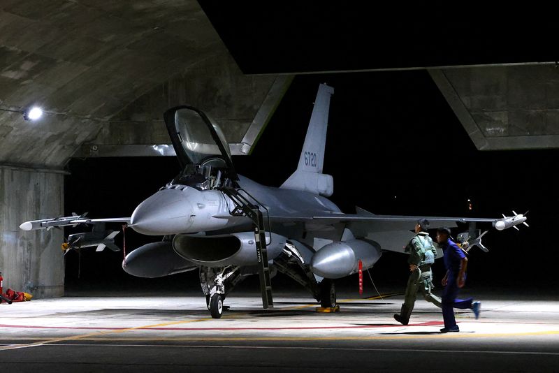 © Reuters. FILE PHOTO: A pilot and Air Force soldier run towards a F-16V fighter jet for an evening take off as part of a combat readiness mission at the airbase in Hualien, Taiwan, August 17, 2022. REUTERS/Ann Wang/File Photo