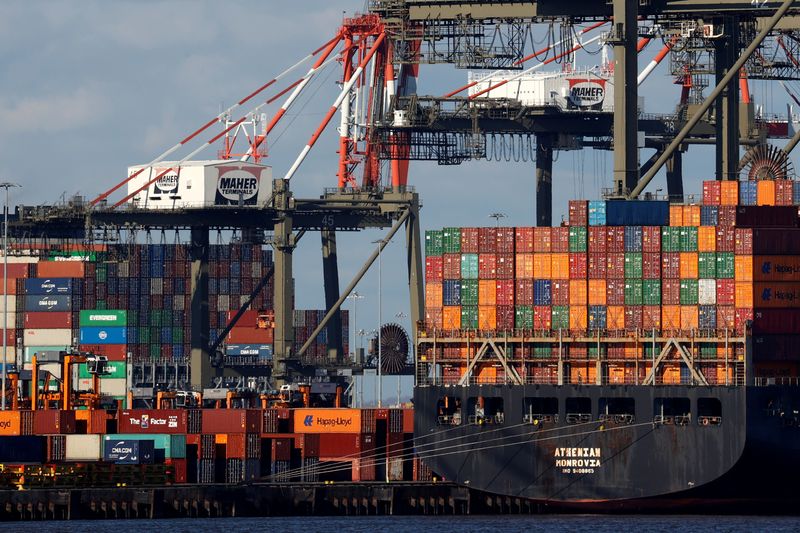 &copy; Reuters. A ship stacked with shipping containers is unloaded on a pier at Port Newark, New Jersey, U.S., November 19, 2021. REUTERS/Mike Segar/File Photo