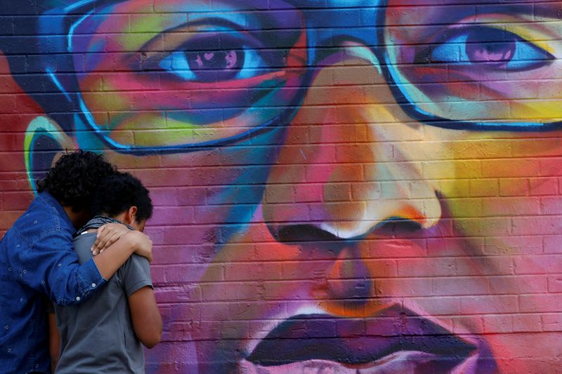 &copy; Reuters. Noah and his older sister visit a mural of Elijah McClain, a 23-year-old Black man who died after an encounter with police officers, ahead of the one year anniversary of his death in Denver, Colorado, U.S., August 8, 2020. REUTERS/Kevin Mohatt     File Ph