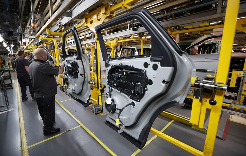 &copy; Reuters. FILE PHOTO: Staff members assemble door panels on the production line at Jaguar Land Rover's Halewood factory in Liverpool, Britain, December 6, 2022. REUTERS/Phil Noble/File Photo