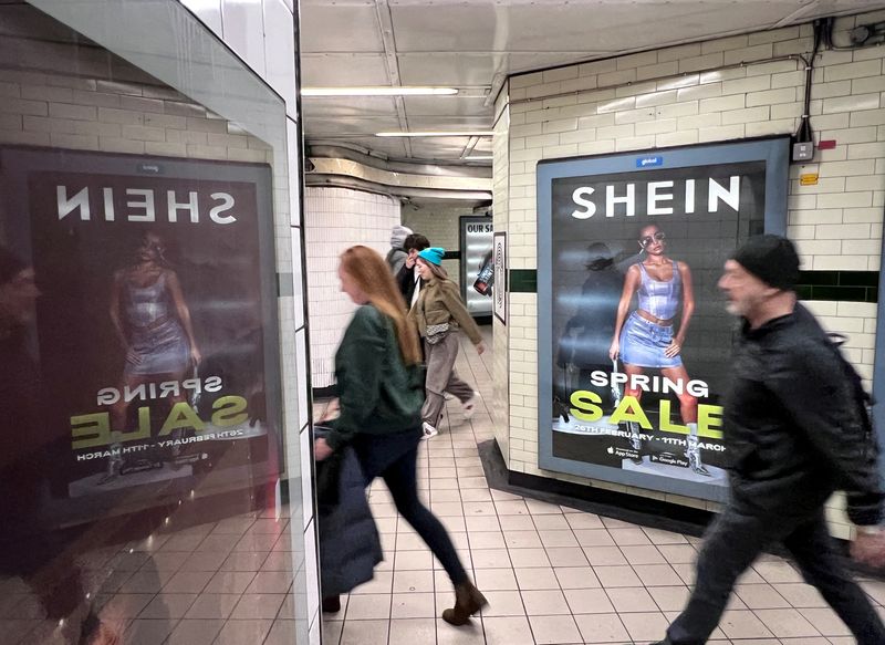 © Reuters. FILE PHOTO: People walk past an advertisement for Shein, March 8, 2024 in London, Britain. REUTERS/Suzanne Plunkett/File Photo