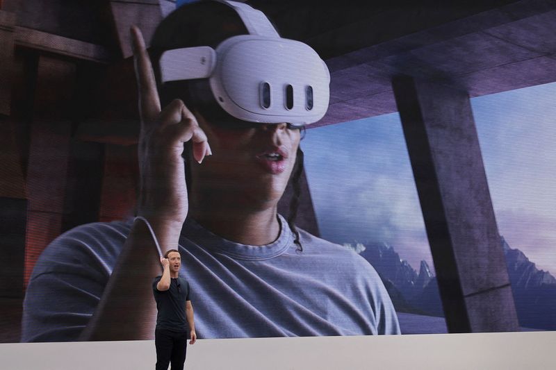 &copy; Reuters. FILE PHOTO: Meta CEO Mark Zuckerberg delivers a speech, as a person wearing a VR headset appears on screen, during the Meta Connect event at the company's headquarters in Menlo Park, California, U.S., September 27, 2023. REUTERS/Carlos Barria/File Photo