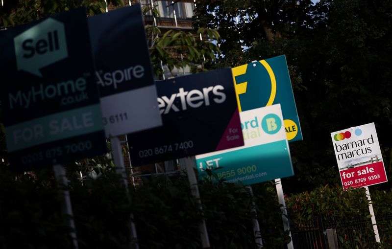 &copy; Reuters. FILE PHOTO: Property estate agent sales and letting signs are seen attached to railings outside an apartment building in south London, Britain, September 23, 2021. REUTERS/Hannah McKay/File Photo