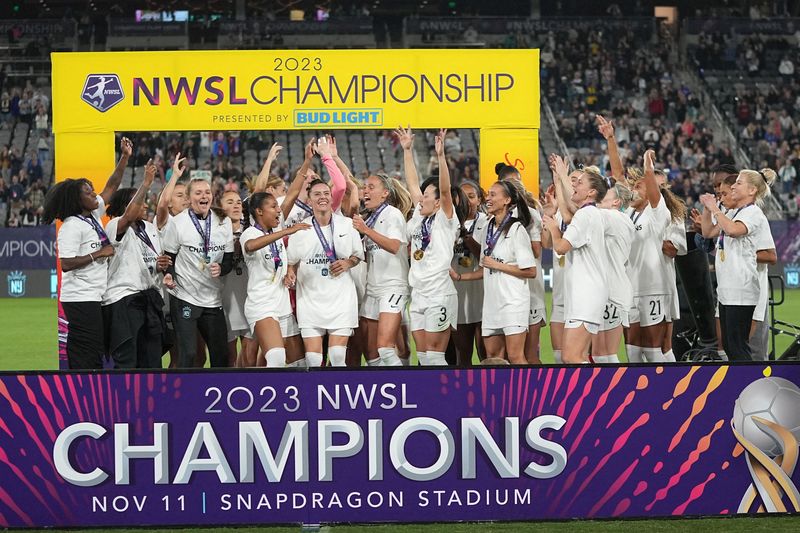 © Reuters. FILE PHOTO: Nov 11, 2023; San Diego, California, USA; New Jersey/New York Gotham FC players celebrate on stage after defeating the OL Reign in the NWSL Championship at Snapdragon Stadium. Mandatory Credit: Ray Acevedo-USA TODAY Sports/File Photo