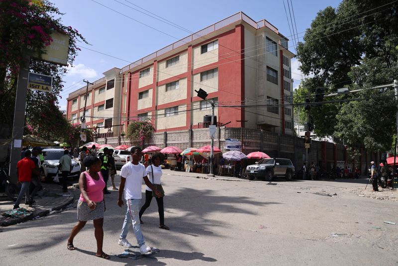 &copy; Reuters. People walk by the Canado-Haitien College before the arrival of Prime Minister Garry Conilleas, as part of a State inspection of schools during the final bachelors degree exams, in Port-au-Prince, Haiti August 6, 2024. REUTERS/Ralph Tedy Erol/File Photo