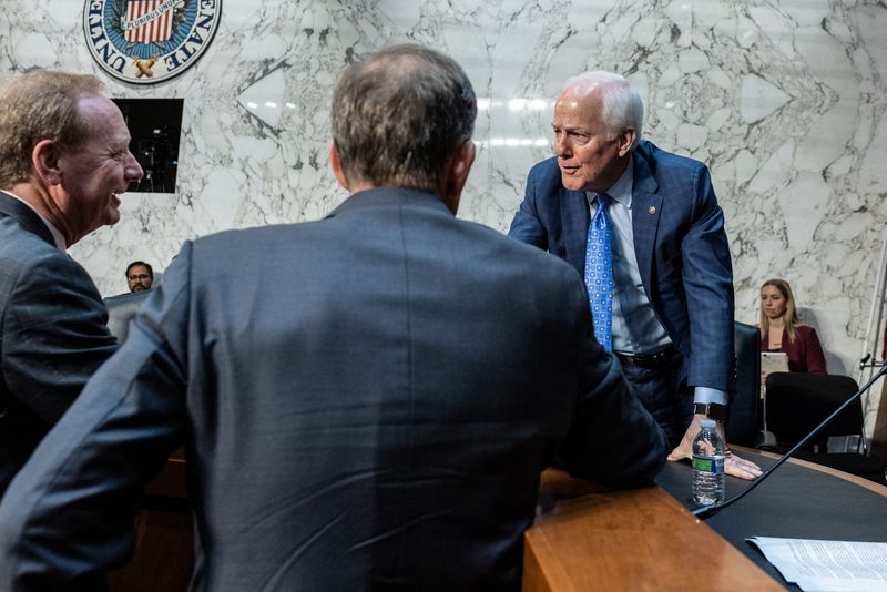 &copy; Reuters. Google parent Alphabet's global affairs president Kent Walker and Microsoft President Brad Smith greet U.S. Senator John Cornyn (R-TX) before a Senate Intelligence Committee hearing on election threats, on Capitol Hill in Washington, U.S., September 18, 2