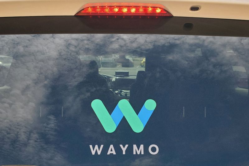 © Reuters. FILE PHOTO: The rear window of a Waymo Chrysler Pacifica robot taxi is seen as it is parked at a Target store in Tempe, Arizona, U.S., August 31, 2021. REUTERS/Paresh Dave/File Photo