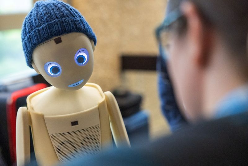 &copy; Reuters. FILE PHOTO: A visitor talks with the Navel robot, by Navel Robotics, during the AI for Good Global summit on artificial intelligence, organised by the International Telecommunication Union (ITU), in Geneva, Switzerland, May 30, 2024. REUTERS/Denis Balibou