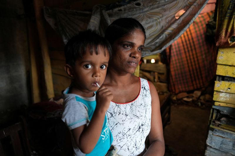 © Reuters. Lankika Dilrukshi, 31, with her son are pictured at her home in Thotalanga, Colombo, Sri Lanka September 9, 2024. REUTERS/Thilina Kaluthotage/File Photo