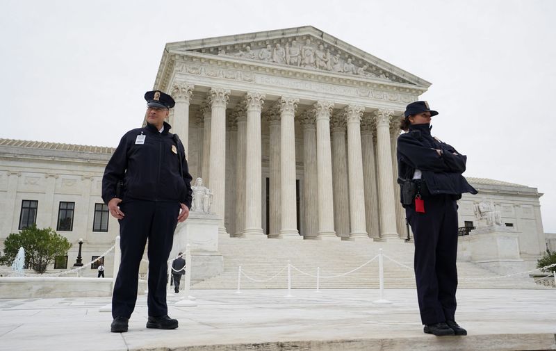 © Reuters. U.S. Supreme Court police officers stand on the front steps of the Supreme Court building prior to the official investiture ceremony for the court's newest Associate Justice Ketanji Brown Jackson and the start of the court's 2022-2023 term in Washington, U.S. September 30, 2022. REUTERS/Kevin Lamarque