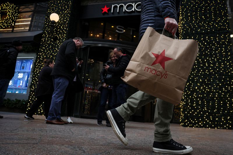 &copy; Reuters. FILE PHOTO: A customer exits the Macy's flagship department store in midtown Manhattan in New York City, U.S., December 11, 2023.  REUTERS/Brendan McDermid/File Photo