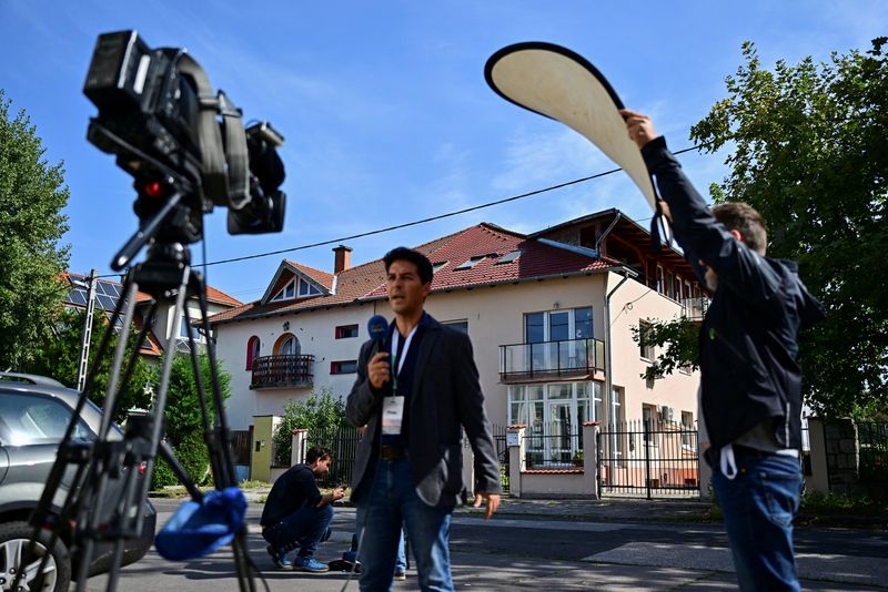 &copy; Reuters. FILE PHOTO: A TV crew operates in front of the office building where BAC Consulting KFT is said to be registered, in Budapest, Hungary, September 18, 2024. Taiwan's Gold Apollo said in a statement that BAC has a license to use its brand and made the model