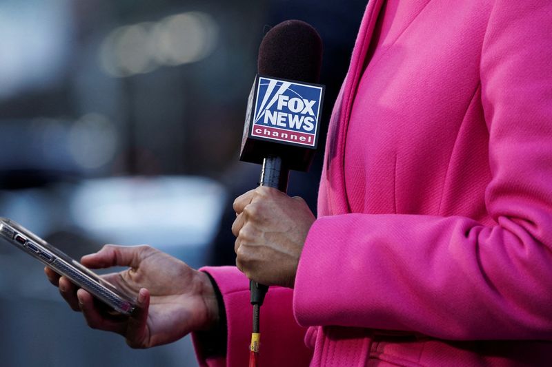 &copy; Reuters. FILE PHOTO: A Fox News TV reporter broadcasts from outside Manhattan Criminal Court after former U.S. President Donald Trump's indictment by a Manhattan grand jury following a probe into hush money paid to porn star Stormy Daniels, in New York City, U.S.,