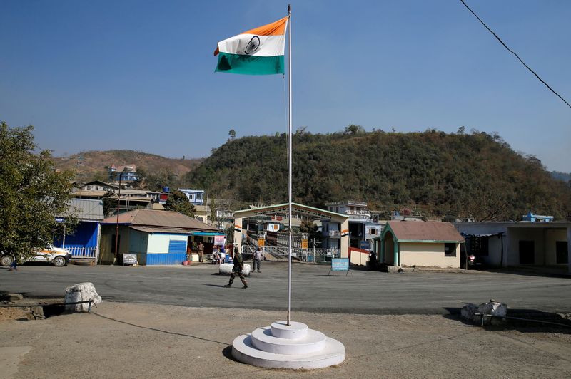 © Reuters. FILE PHOTO: An Indian national flag flies next to an immigration check post on the India-Myanmar border in Zokhawthar village in Champhai district of India's northeastern state of Mizoram, India, March 16, 2021. REUTERS/Rupak De Chowdhuri/File Photo