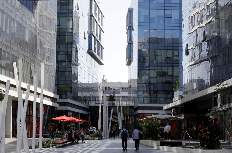 &copy; Reuters. FILE PHOTO: Men walk near high-rise buildings in the high-tech business area of Tel Aviv, Israel May 15, 2017.REUTERS/Amir Cohen/File Photo