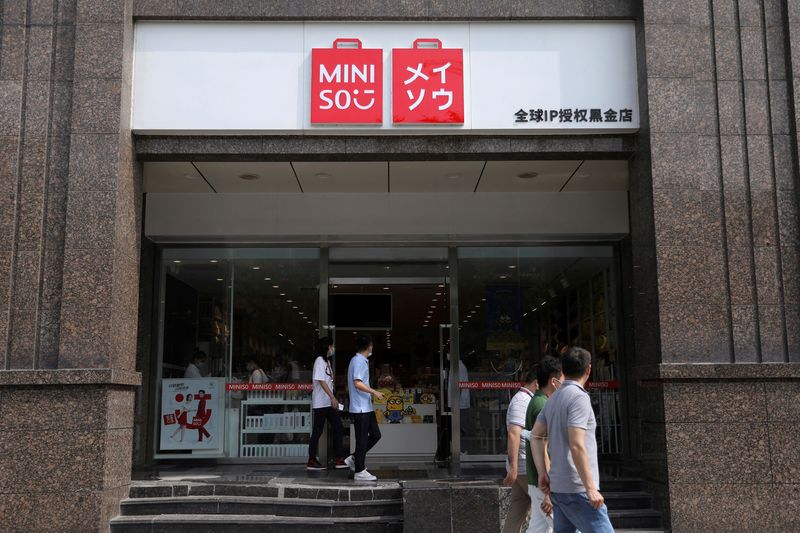 &copy; Reuters. FILE PHOTO: People walk past a store of Chinese retailer MINISO Group in Beijing, China September 13, 2021. REUTERS/Tingshu Wang/File Photo