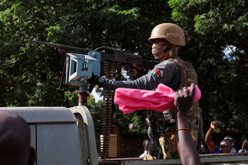 &copy; Reuters. FILE PHOTO: New junta's soldiers stand guard in an armoured vehicle in Ouagadougou, Burkina Faso October 2, 2022. REUTERS/Vincent Bado//File Photo