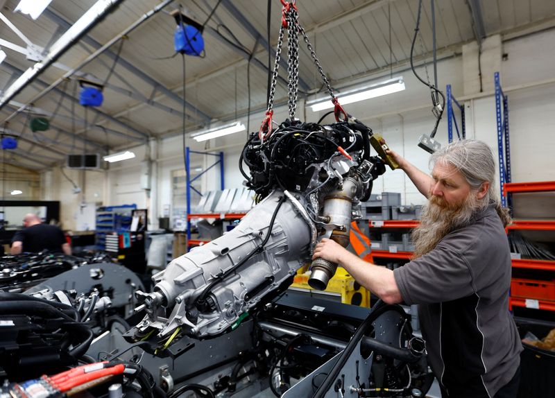 © Reuters. FILE PHOTO: A member of staff works on a car production at the Morgan Motor Company factory in Malvern, Britain, May 12, 2023. REUTERS/Andrew Boyers/File photo