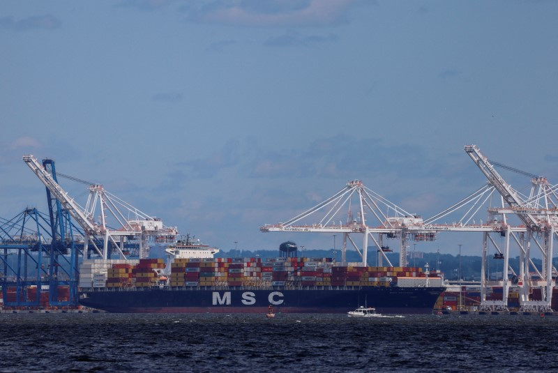 &copy; Reuters. FILE PHOTO: A small boat passes by a cargo ship near the Seagirt Marine Terminal as the main shipping channel at the Port of Baltimore prepares to fully reopen, in Baltimore, Maryland, U.S., June 10, 2024. REUTERS/Evelyn Hockstein/File Photo