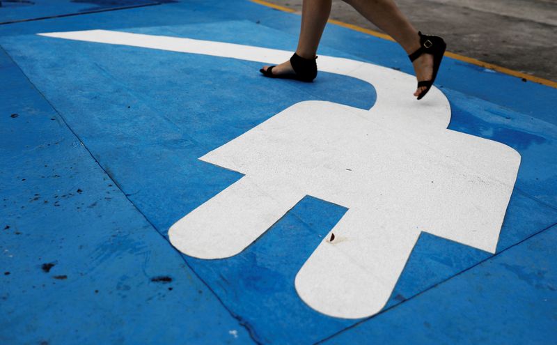 &copy; Reuters. FILE PHOTO: An electric car charging sign is seen in a car park at a petrol station in Sao Paulo, Brazil, March 3, 2018. REUTERS/Nacho Doce/File Photo