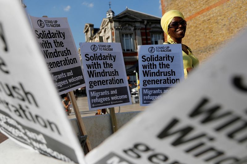 &copy; Reuters. FILE PHOTO: A woman attends an event in Windrush Square to show solidarity with the Windrush generation in the Brixton district of London, Britain April 20, 2018.  REUTERS/Darren Staples/File Photo