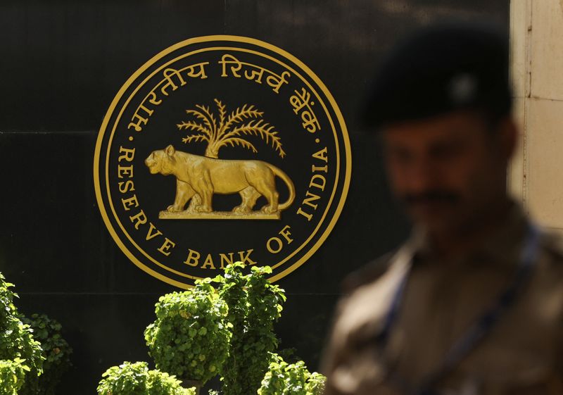 © Reuters. FILE PHOTO: A police officer walks past the Reserve Bank of India (RBI) logo at its headquarters in Mumbai, India, April 6, 2023. REUTERS/Francis Mascarenhas/File Photo