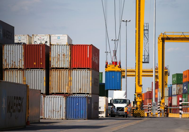 © Reuters. FILE PHOTO: A shipping container is offloaded from a truck in the Port of Montreal in Montreal, Quebec, Canada, May 17, 2021. REUTERS/Christinne Muschi/File Photo