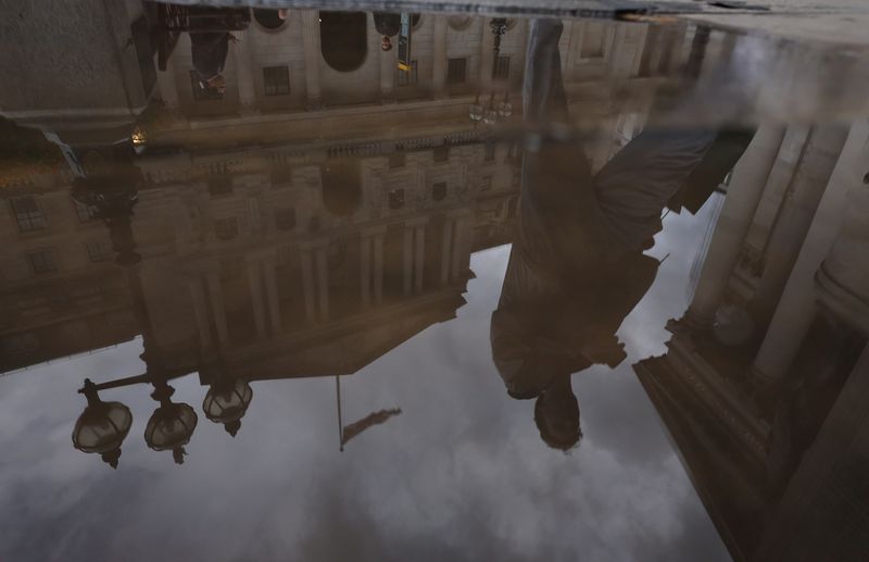 &copy; Reuters. FILE PHOTO: A person walks past the Bank of England, reflected in a puddle, in London, Britain, September 23, 2024. REUTERS/Mina Kim/File Photo