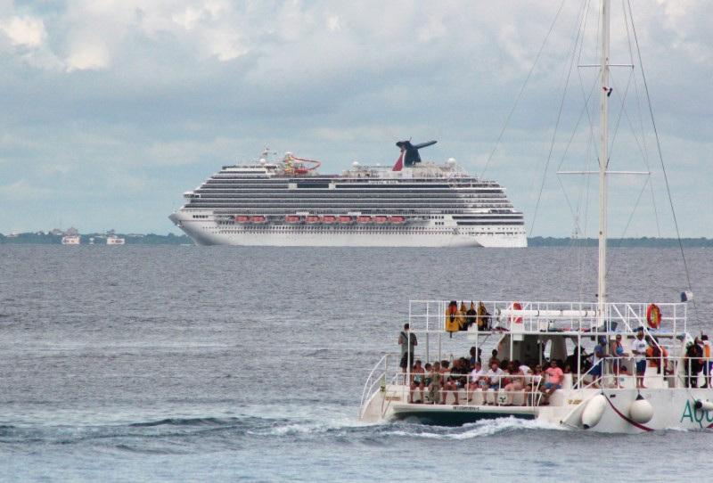 &copy; Reuters. Tourists enjoy a ride on a catamaran as cruise ship Carnival Magic is seen in this file photo.  REUTERS/Stringer/File Photo