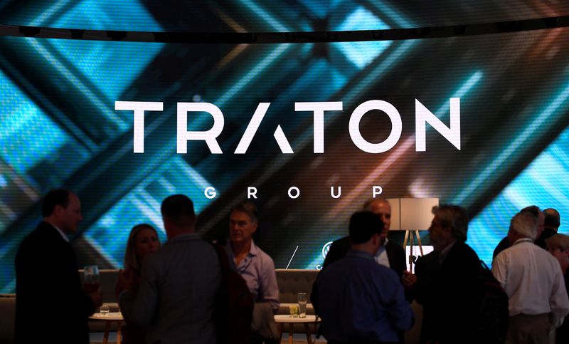 © Reuters. FILE PHOTO: Visitors stand at the booth of Volkswagen's truck unit Traton Group, former Volkswagen Truck & Bus AG, in Hanover, Germany September 19, 2018. REUTERS/Fabian Bimmer/File Photo