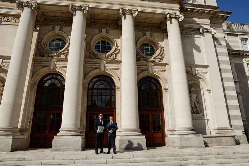 &copy; Reuters. Ireland's Minister for Finance Jack Chambers, and Ireland's Minister for Public Expenditure and Reform Paschal Donohoe stand while holding the Budget 2025 documents in the courtyard of Government Buildings, in Dublin, Ireland, October 1, 2024. REUTERS/Clo