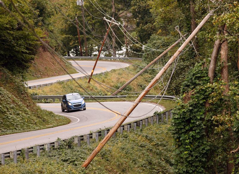 &copy; Reuters. Power line poles lean after Tropical Storm Helene caused widespread damage to infrastructure, in Lake Lure, North Carolina, U.S. October 1, 2024. REUTERS/Jonathan Drake